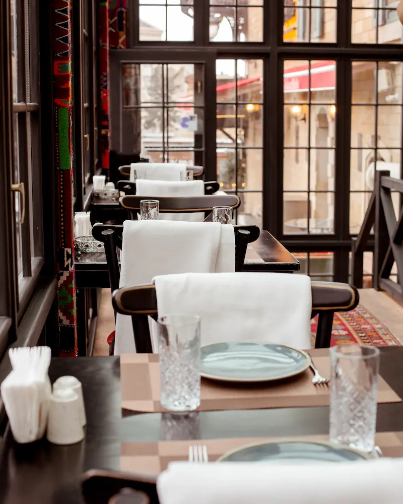 A split-screen showing a generic template website transforming into a bespoke, custom-designed luxury restaurant website.